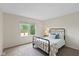 Well-lit bedroom with a metal bed frame, neutral walls, and bright window with view at 5208 Clear Lake Ct, Carmel, IN 46033