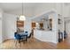 Dining area with modern light fixture, seating for four, and a pass-through to the kitchen at 5208 Clear Lake Ct, Carmel, IN 46033