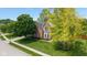 Charming brick home with mature trees, manicured lawn, and a quaint bay window at 5208 Clear Lake Ct, Carmel, IN 46033