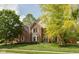 Charming brick home with manicured lawn, mature trees, and lovely curb appeal at 5208 Clear Lake Ct, Carmel, IN 46033