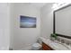 Half bath features a granite-topped sink, decorative mirror, and a toilet at 5208 Clear Lake Ct, Carmel, IN 46033