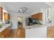 Well-lit kitchen features wooden cabinets, granite countertops, stainless steel appliances, and a view to the dining area at 5208 Clear Lake Ct, Carmel, IN 46033