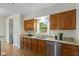 The kitchen showcases granite counters, wooden cabinets, stainless steel appliances, and natural light at 5208 Clear Lake Ct, Carmel, IN 46033