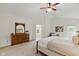 Spacious main bedroom featuring a ceiling fan, ensuite bathroom, and a large dresser with mirror at 5208 Clear Lake Ct, Carmel, IN 46033