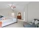 Spacious main bedroom with a ceiling fan, ensuite bathroom, and a comfortable chaise lounge at 5208 Clear Lake Ct, Carmel, IN 46033