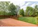 Expansive wooden deck overlooks a large, manicured backyard with lush landscaping and playset at 5208 Clear Lake Ct, Carmel, IN 46033