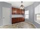 Eat-in kitchen with wooden cabinetry and modern lighting fixture at 6275 Eller Creek Way, Fishers, IN 46038