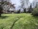 Large backyard with a trampoline, shade trees, and endless possibilities for Gathering fun at 6632 Sargent Rd, Indianapolis, IN 46256
