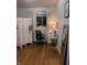 Cozy bedroom featuring a white screen divider, wooden floors, desk and black office chair at 6632 Sargent Rd, Indianapolis, IN 46256