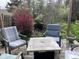 Relaxing outdoor deck space with comfortable chairs, a fire pit, and beautiful landscaping at 6632 Sargent Rd, Indianapolis, IN 46256