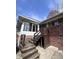 Rear exterior view showcasing a wooden deck with stairs and brick facade at 6632 Sargent Rd, Indianapolis, IN 46256