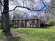 Beautiful home with a well-maintained lawn, adorned with a charming tree swing at 6632 Sargent Rd, Indianapolis, IN 46256