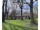 Lovely home with a well-manicured lawn, framed by mature trees at 6632 Sargent Rd, Indianapolis, IN 46256