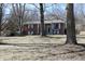 Charming brick home with a covered front porch and large trees, creating a welcoming and serene curb appeal at 6632 Sargent Rd, Indianapolis, IN 46256