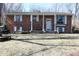 Charming brick home with white trim, shutters, and a covered porch, perfect for relaxing at 6632 Sargent Rd, Indianapolis, IN 46256