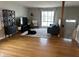 Cozy living room with hardwood floors and a large window, creating a warm and inviting atmosphere at 6632 Sargent Rd, Indianapolis, IN 46256