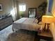 Bright main bedroom showcasing a comfortable bed, ambient lighting, and peaceful decor with hardwood floors at 6632 Sargent Rd, Indianapolis, IN 46256
