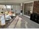 Comfortable sun room features brick accent wall, large window view, seating, and natural light at 6632 Sargent Rd, Indianapolis, IN 46256