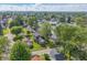 Community aerial view showcasing lush green trees and residential streets on a bright and sunny day at 806 S 17Th St, Elwood, IN 46036