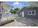 Charming backyard featuring gray siding, a white door, and a concrete patio perfect for outdoor entertaining at 806 S 17Th St, Elwood, IN 46036