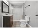 Well-lit bathroom showcases a vanity, mirror, toilet, and shower at 806 S 17Th St, Elwood, IN 46036