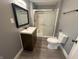 Bathroom featuring a modern vanity, a mirror, and a shower with sliding glass doors at 806 S 17Th St, Elwood, IN 46036