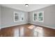 Bright bedroom with hardwood floors and natural light from the two windows at 806 S 17Th St, Elwood, IN 46036