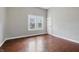 Cozy bedroom features hardwood floors, a window, and a door at 806 S 17Th St, Elwood, IN 46036