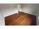 An empty bedroom featuring hardwood floors, neutral walls, and a doorway leading to another room at 806 S 17Th St, Elwood, IN 46036
