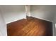 An empty bedroom featuring hardwood floors, neutral walls, and a doorway leading to another room at 806 S 17Th St, Elwood, IN 46036