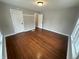 An empty bedroom with hardwood floors and neutral walls boasts natural light at 806 S 17Th St, Elwood, IN 46036