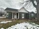Charming home featuring green siding, a white-trimmed roof, and decorative front porch posts at 806 S 17Th St, Elwood, IN 46036