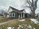 Charming home with green siding, white trim, decorative porch, and a well-kept lawn at 806 S 17Th St, Elwood, IN 46036