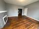 Bright living room featuring wood floors, a brick fireplace, and an open layout at 806 S 17Th St, Elwood, IN 46036