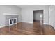 Open living room with fireplace, light gray walls and hardwood flooring at 806 S 17Th St, Elwood, IN 46036