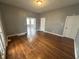 Large living room with beautiful hardwood flooring, offering ample space and natural light at 806 S 17Th St, Elwood, IN 46036