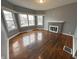 Inviting living room featuring gleaming wood floors, a brick fireplace, and large windows at 806 S 17Th St, Elwood, IN 46036