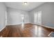 Spacious living room with hardwood floors, light walls, and glass doors leading to a kitchen at 806 S 17Th St, Elwood, IN 46036
