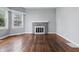 Cozy living room boasts hardwood floors, a brick fireplace, and plenty of natural light at 806 S 17Th St, Elwood, IN 46036