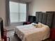 Bedroom with a large bed, high headboard, and a sitting area by the bright window at 9101 S Stone Trace S Blvd, Avon, IN 46123
