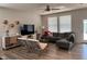 Bright living room features a sleek gray sectional sofa, modern decor, and natural light from large windows at 9101 S Stone Trace S Blvd, Avon, IN 46123