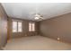 Neutral bedroom with ceiling fan, carpet, and dual windows providing natural light at 1156 Canterbury N Sq, Indianapolis, IN 46260
