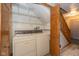 Laundry room with washer, dryer, built-in shelving and stairway at 1156 Canterbury N Sq, Indianapolis, IN 46260