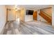 Spacious living room featuring wood floors, stairs, and a mounted TV for entertainment at 1156 Canterbury N Sq, Indianapolis, IN 46260