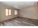 Bright living room with new wood floors, neutral paint, and natural light from large windows at 1156 Canterbury N Sq, Indianapolis, IN 46260