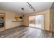 Living room featuring wood floors, an adjacent kitchen and access to an outdoor patio at 1156 Canterbury N Sq, Indianapolis, IN 46260