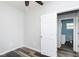 Bedroom featuring a door leading to the ensuite bathroom, with wood-look flooring at 117 W 36Th St, Indianapolis, IN 46208