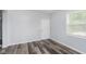 Neutral bedroom with hardwood floors, white door, and light gray walls at 117 W 36Th St, Indianapolis, IN 46208