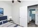 Bedroom with stylish bed, ceiling fan, and an en-suite bathroom at 117 W 36Th St, Indianapolis, IN 46208