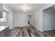 Open dining area with modern chandelier and wood-look flooring, offering ample natural light at 117 W 36Th St, Indianapolis, IN 46208